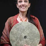 Emily Jarrett Hughes holding a drum and smiling