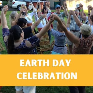 People gathered in a spiral dance with arms raised with words "Earth Day Celebration"