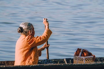 A south Asian woman solo paddles her boat